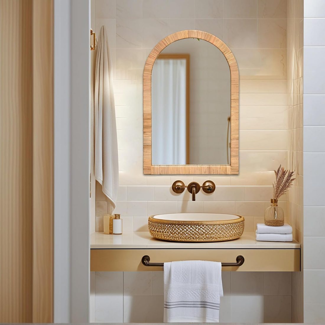 Arched rattan wall mirror with a woven frame above a bathroom sink